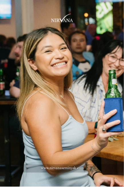 Woman with beer on hand in the Sports Bar